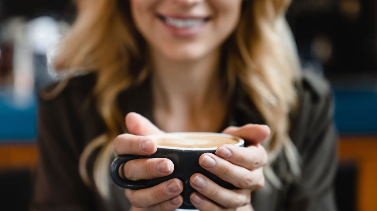 Šálek kávy s mlékem na stole